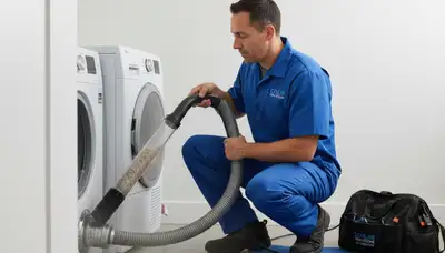 Technician performing professional dryer vent cleaning in Silver Spring, MD home